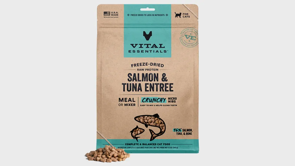 A bag of Vital Essentials freeze-dried salmon and tuna entree cat food, with some kibble pieces in front.